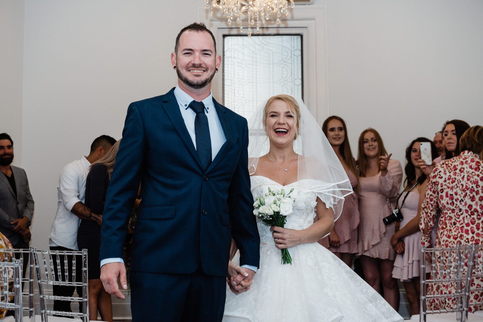 The bride and groom pose for a photo after the wedding ceremony.