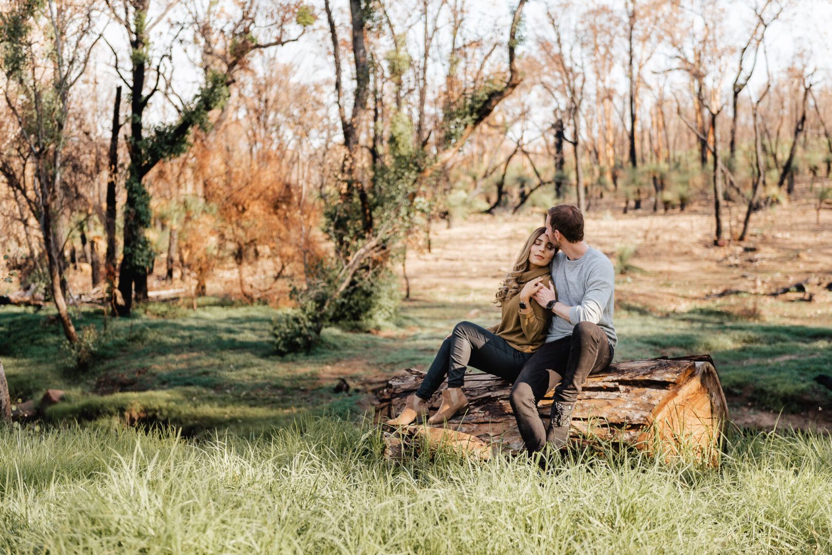 A couple seats together on a trunk at Noble Falls