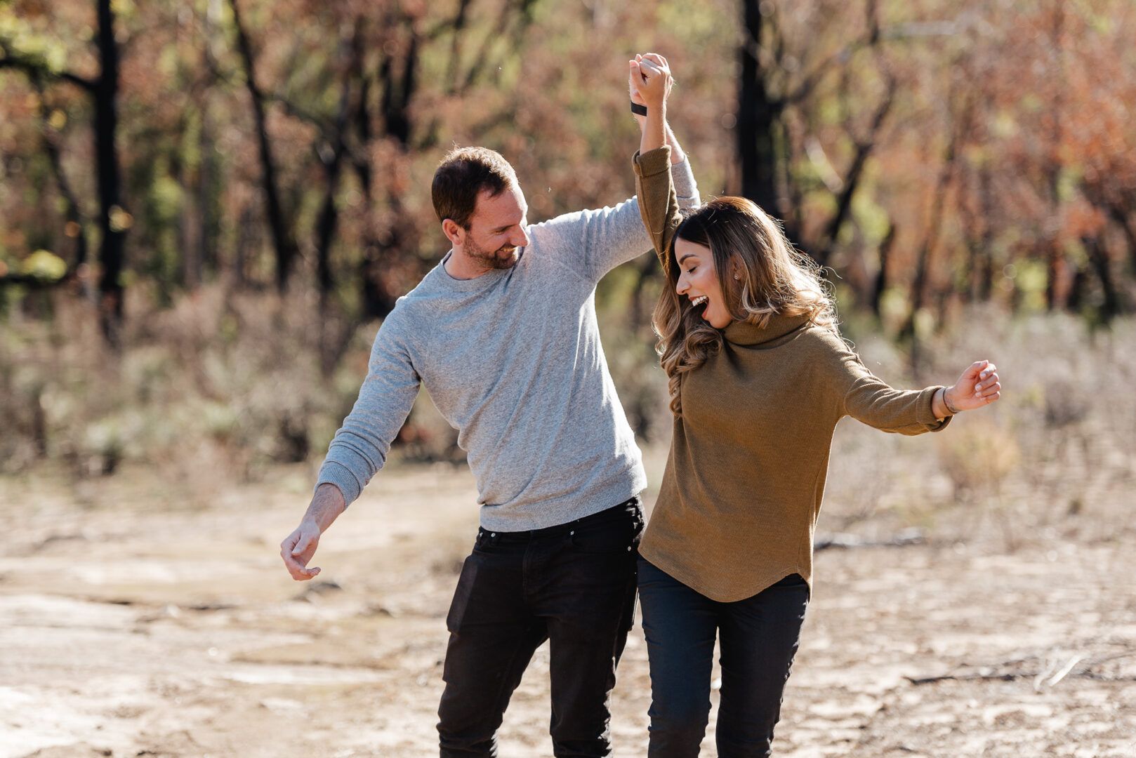 A couple pushes each other while walking together