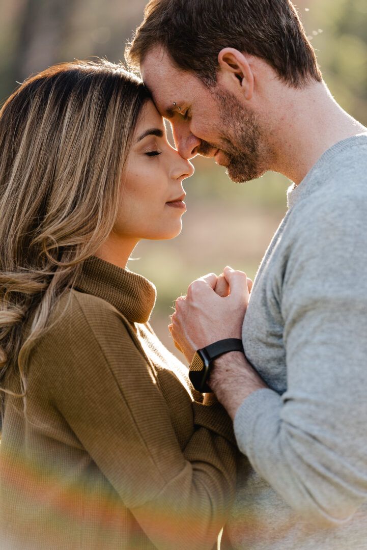 A cclose up of a couple touching forehead together at Noble Falls